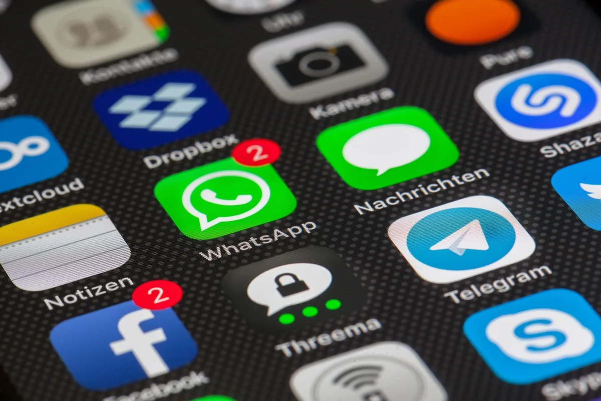 Téléphone affichant notifications et promotions beauté en plein jour
